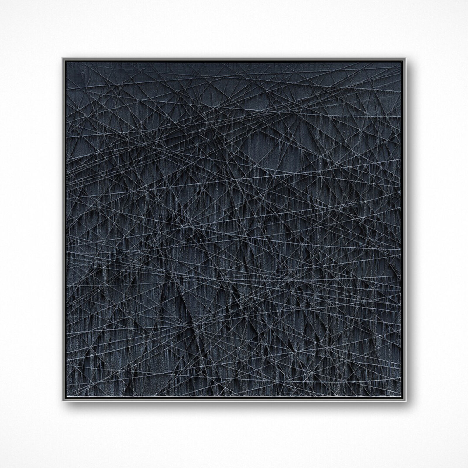 A textured abstract artwork featuring a dark, charcoal surface crisscrossed with fine white lines.