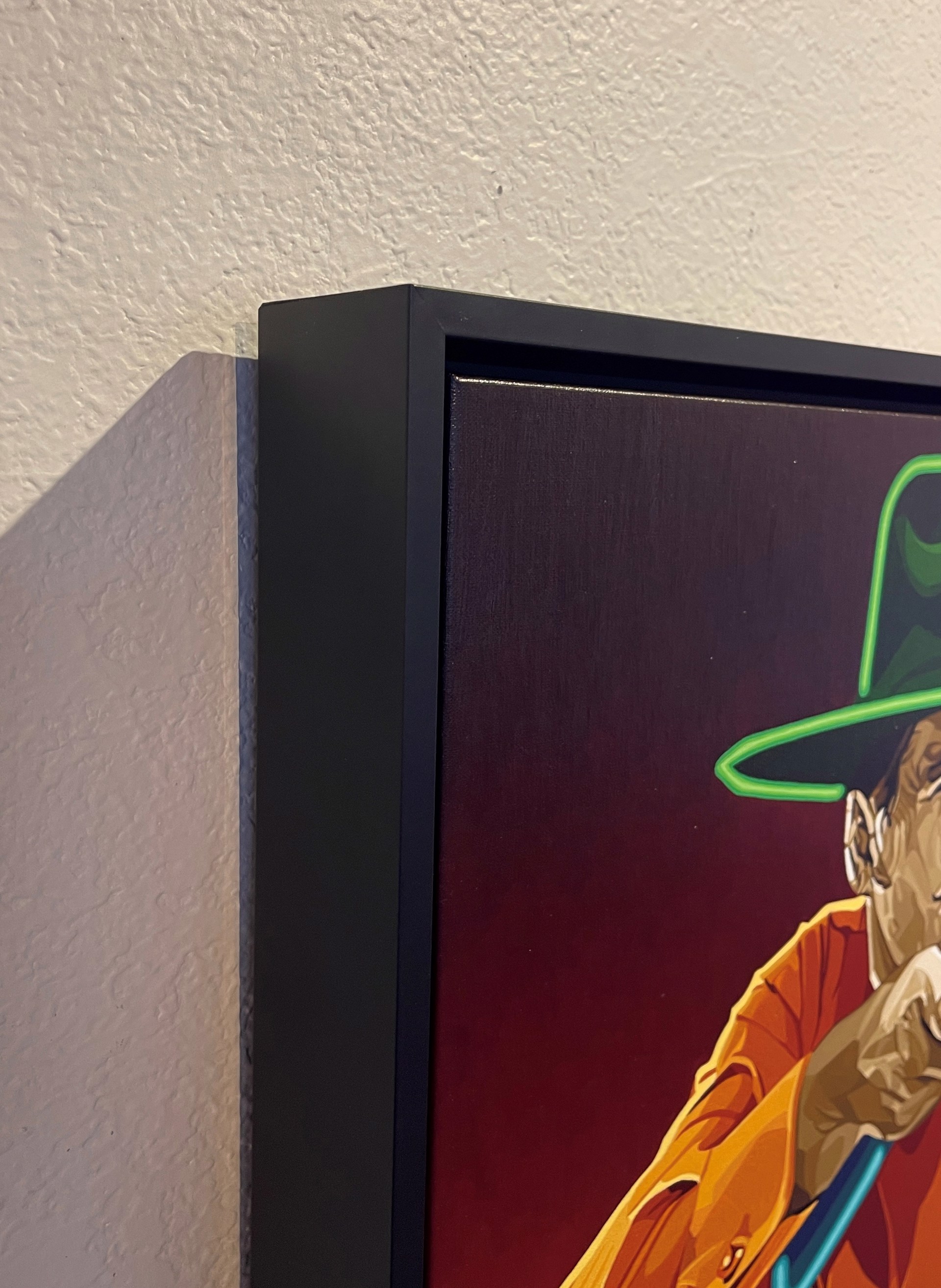 A stylized portrait of a figure in a cowboy hat aiming a blue revolver at an unseen target.
