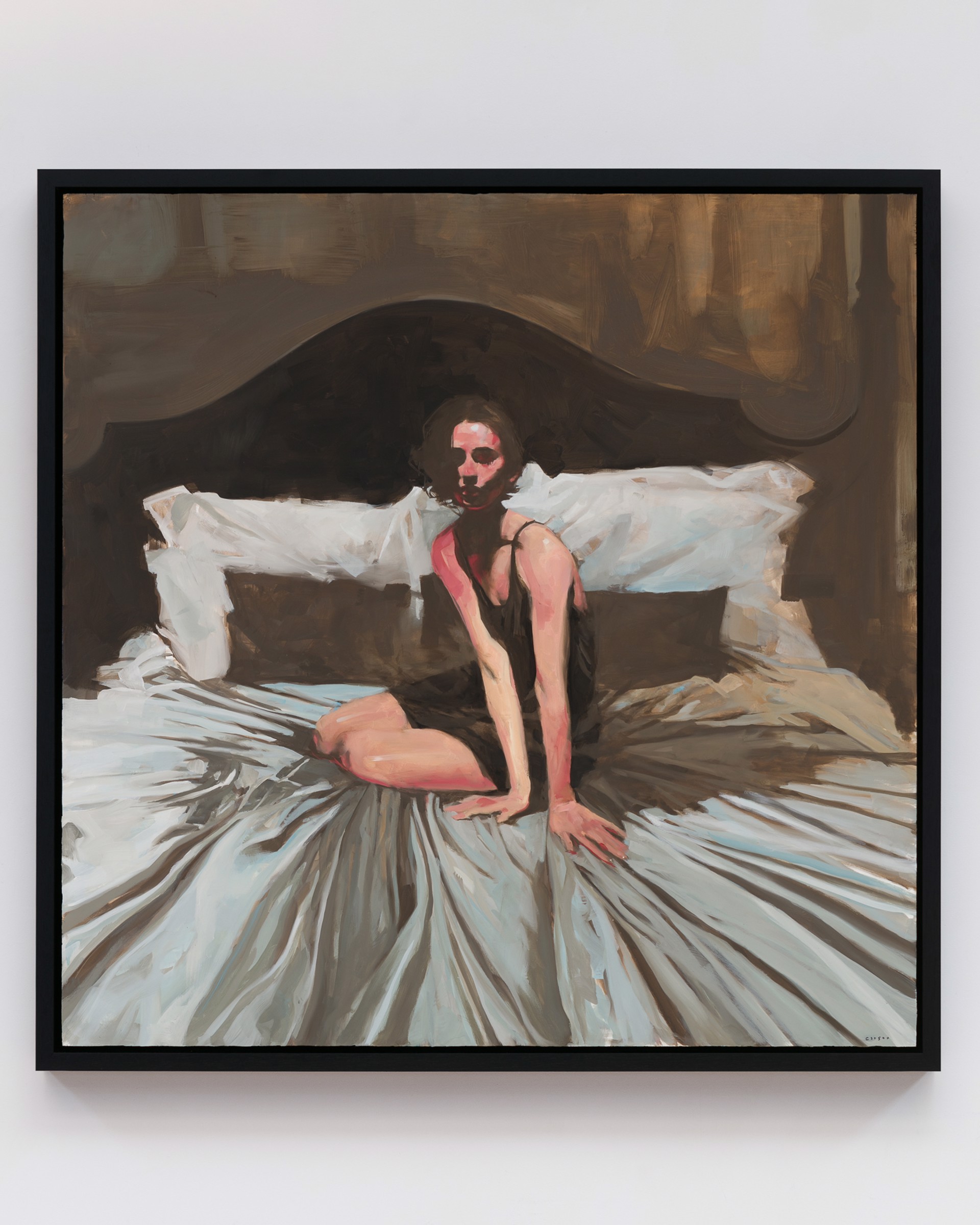A figure sits on a bed in a dimly lit, intimate bedroom scene.