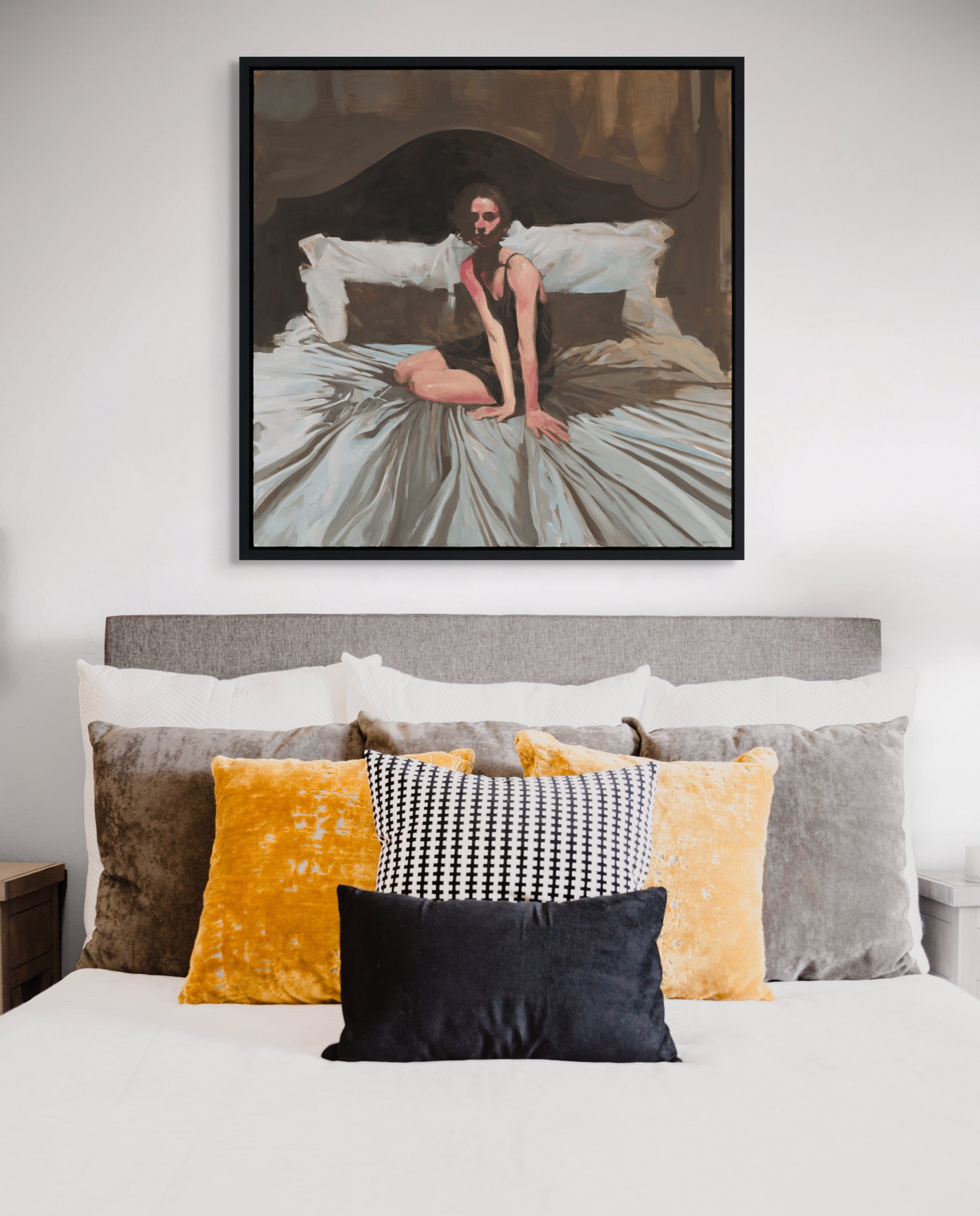 A figure sits on a bed in a dimly lit, intimate bedroom scene.
