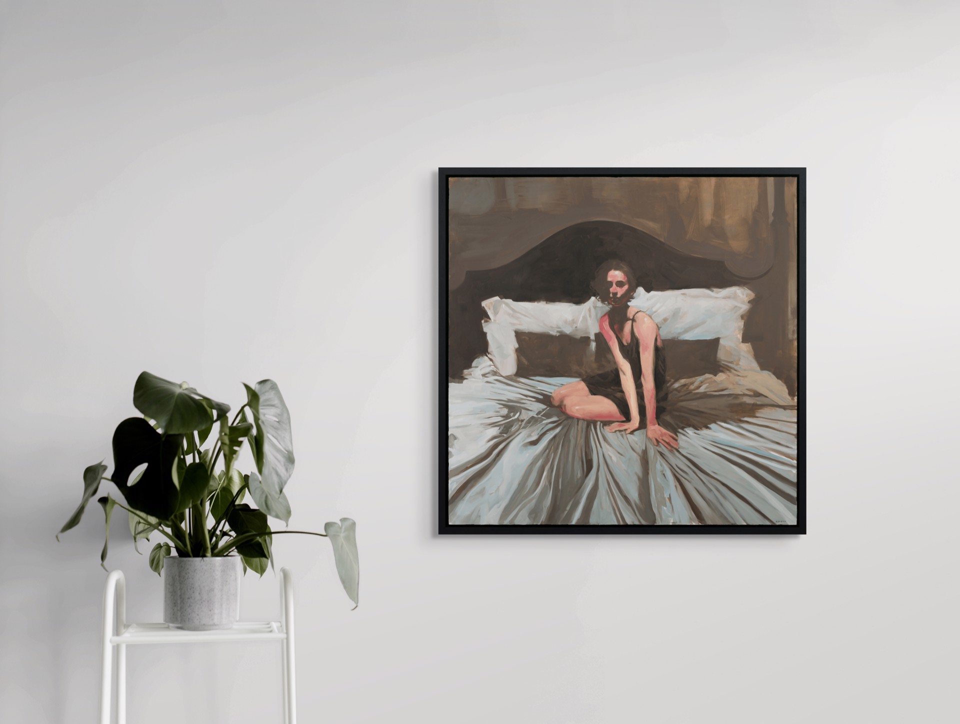 A figure sits on a bed in a dimly lit, intimate bedroom scene.