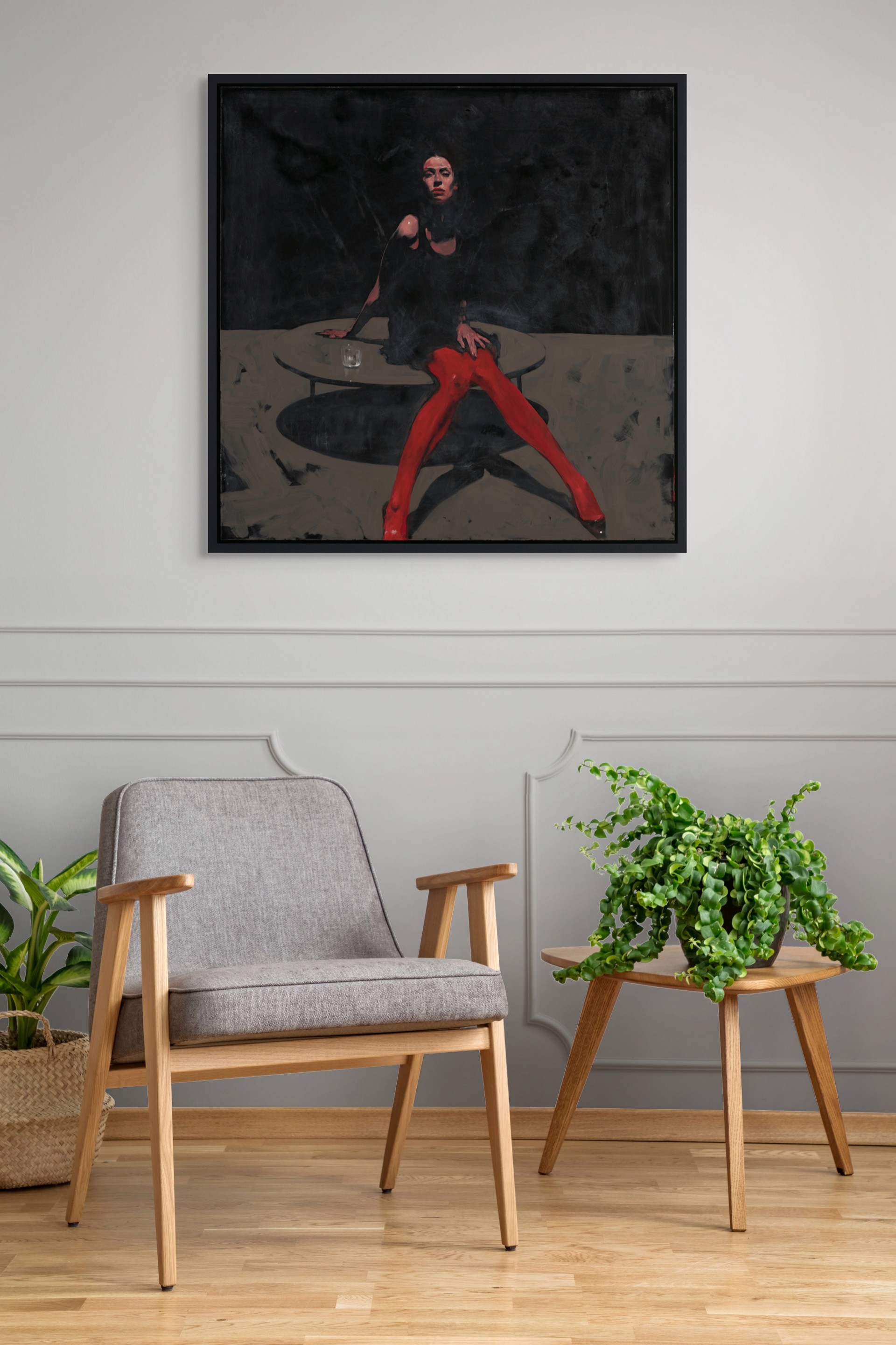 A dramatic painting of a figure in red tights seated at a table against a dark background.