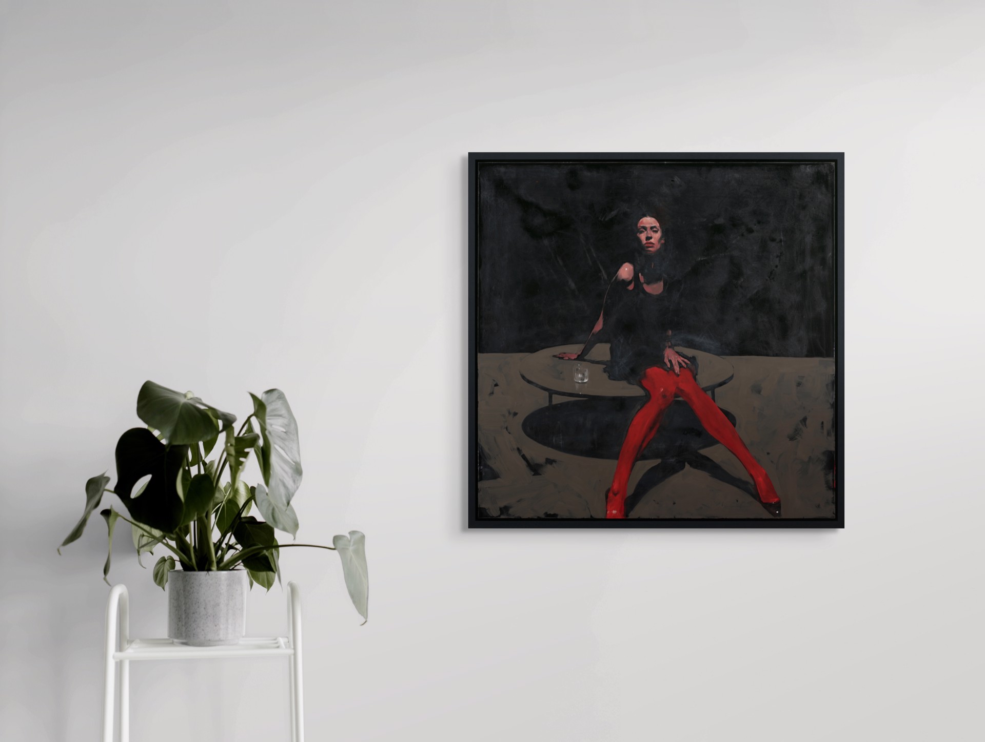A dramatic painting of a figure in red tights seated at a table against a dark background.
