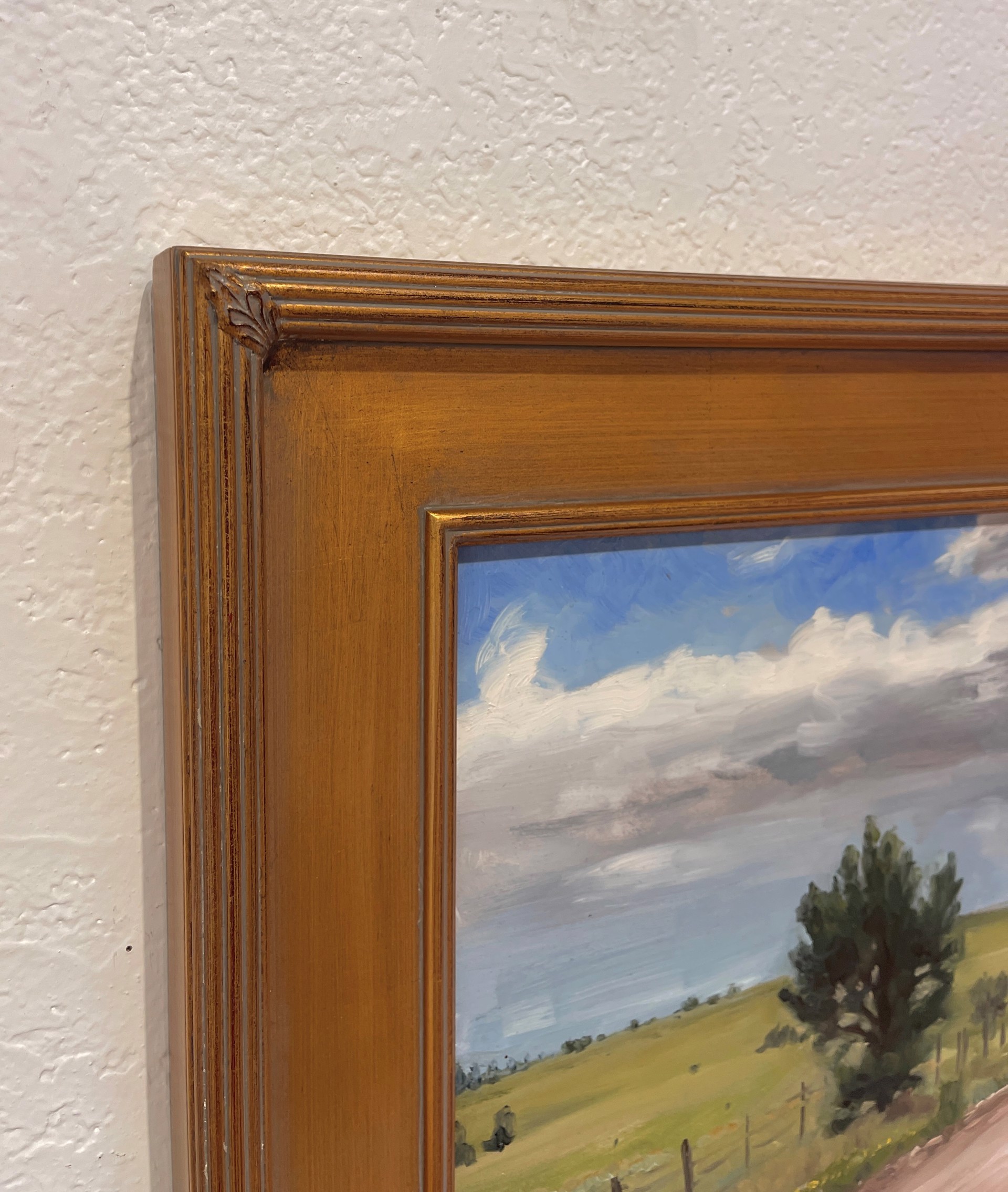 A painting of a dirt road in the middle of a field.