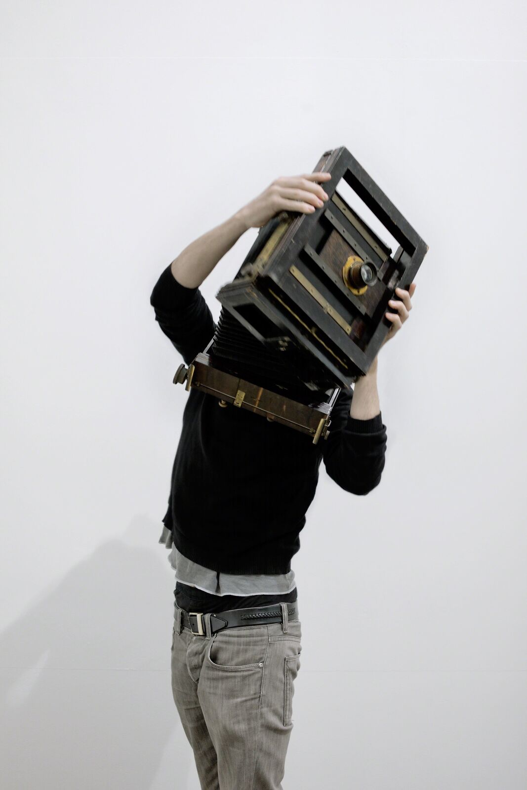 A man holding a camera over his head. 