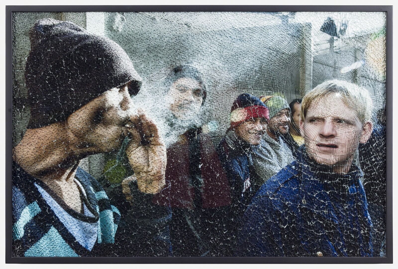 A group of people standing next to each other in front of a window.