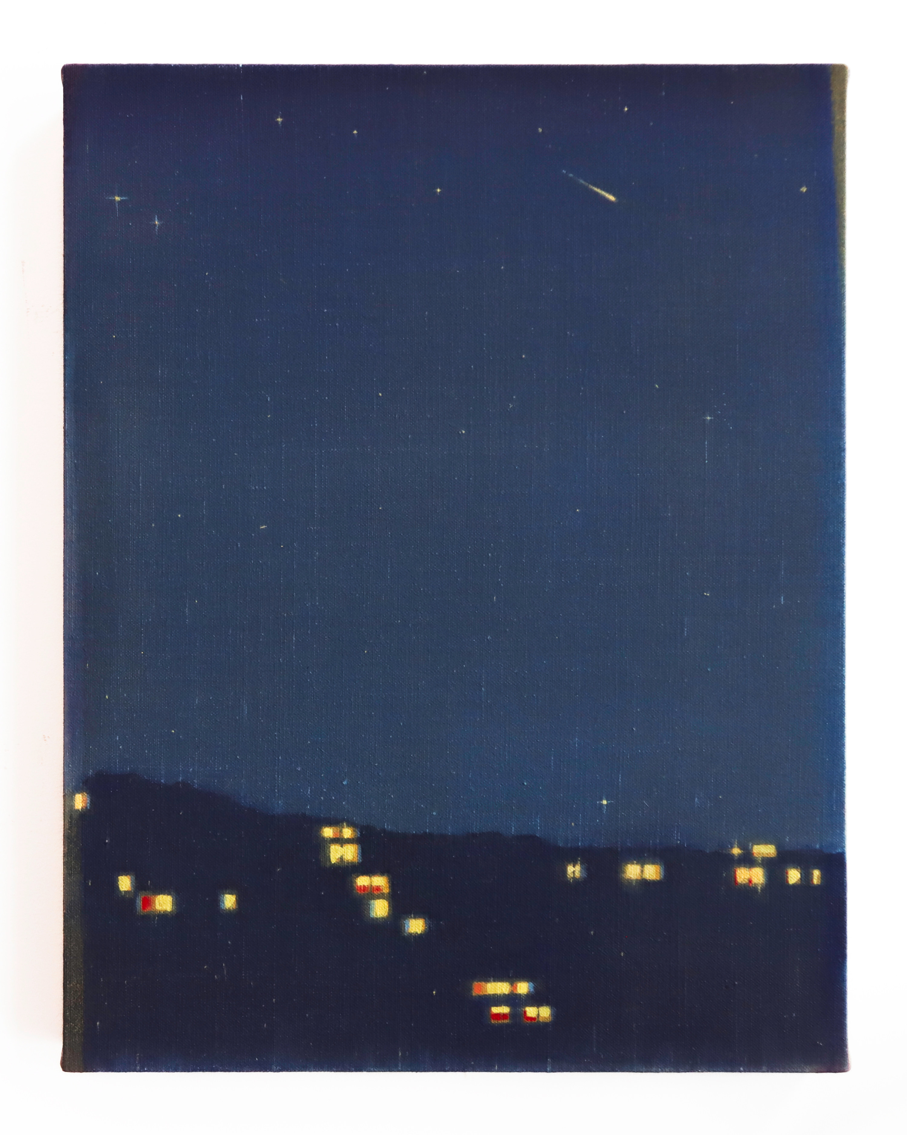 A picture of a night sky with a shooting star in the sky.