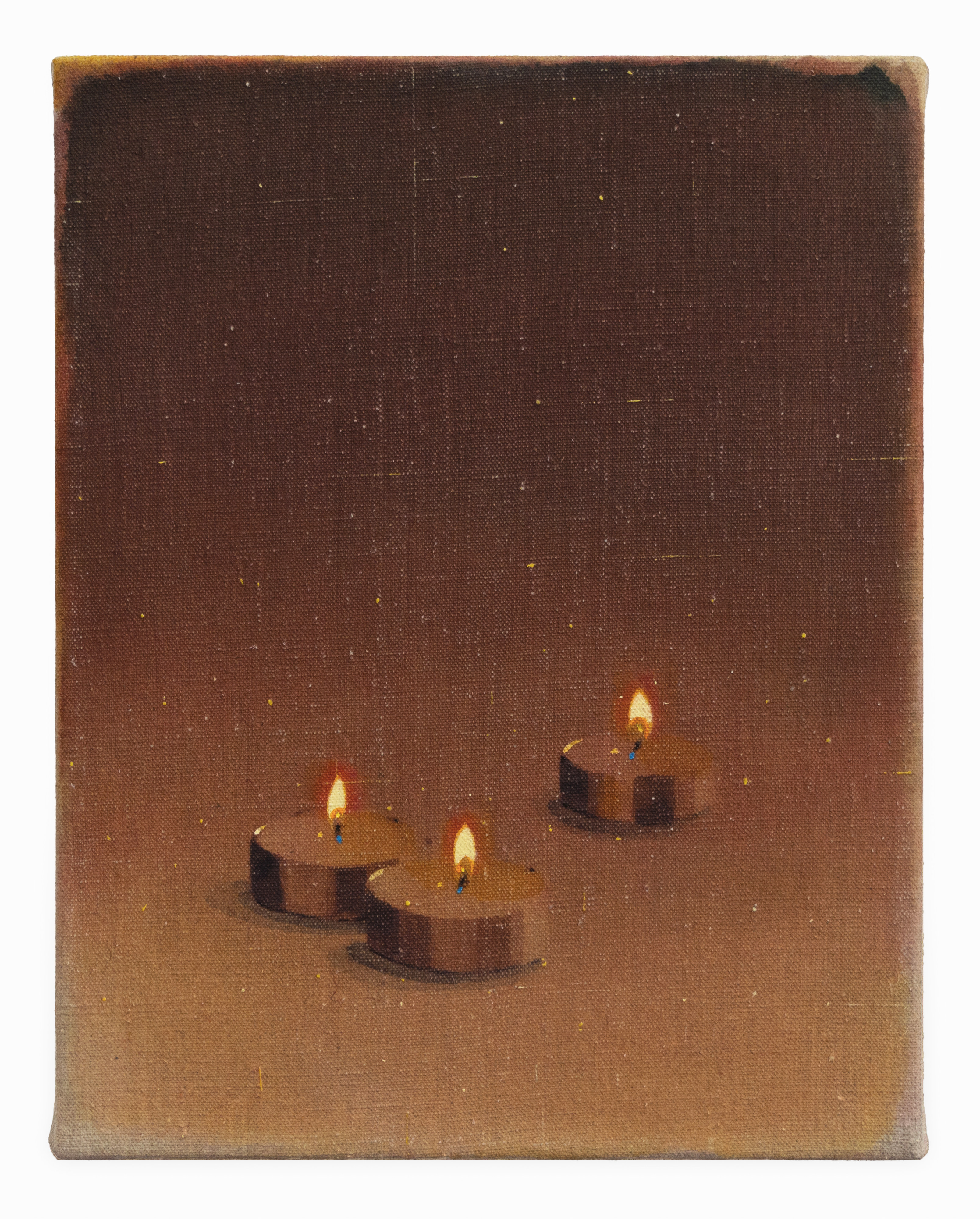 Three lit candles on a brown background. 