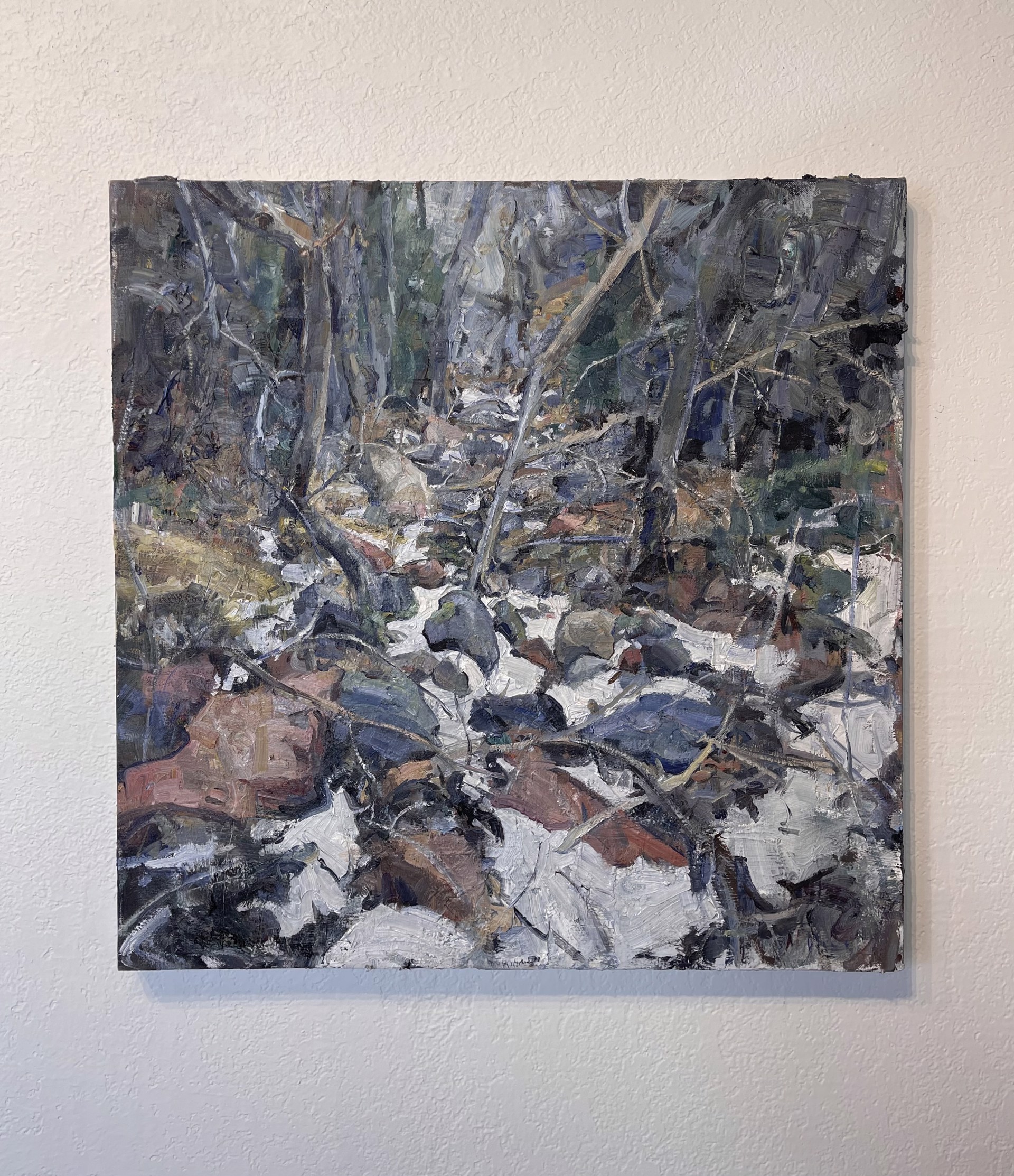 A painting of rocks and trees in the woods.