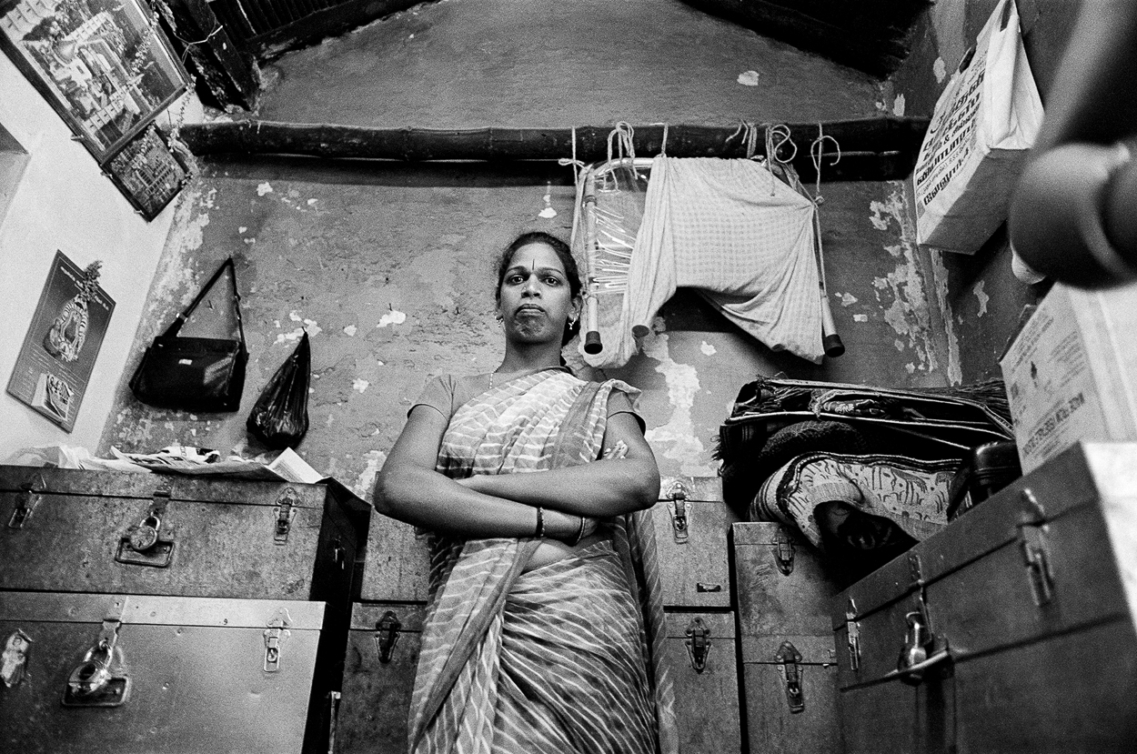 A woman standing in a room with her arms crossed.