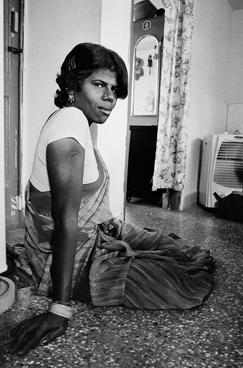 A woman sitting on the floor in a room.