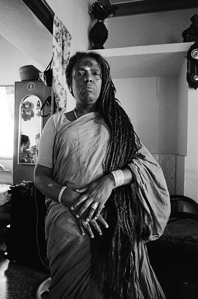 A woman with dreadlocks standing in a room.