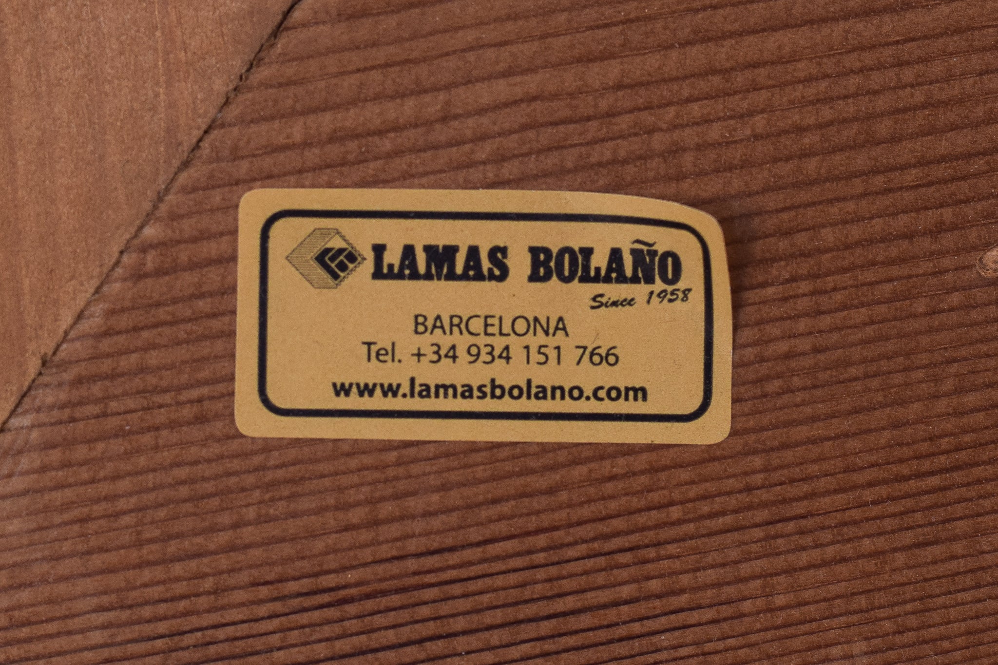 A painting of three women sitting on a chair.