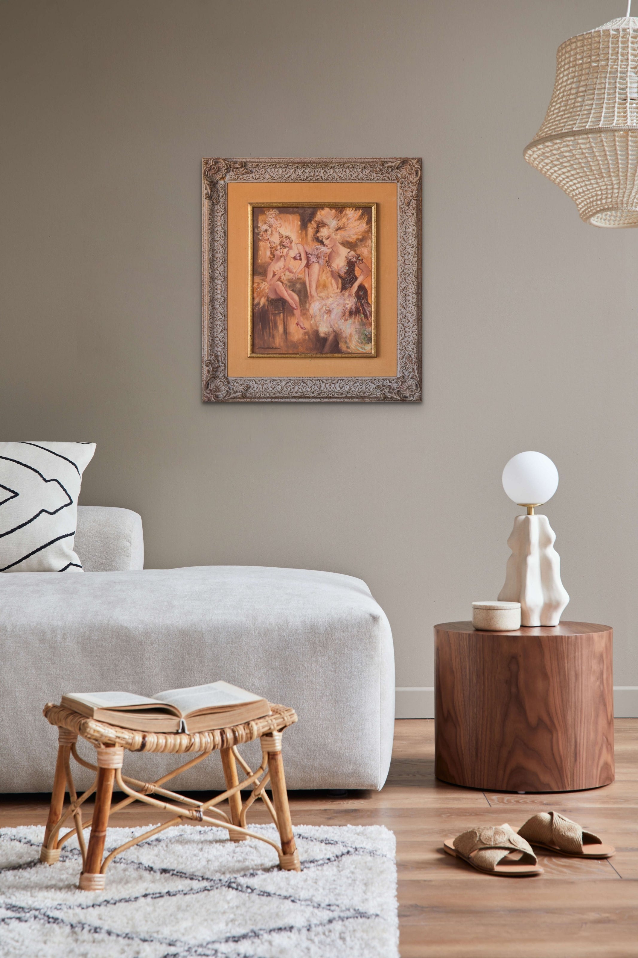 A painting of three women sitting on a chair.