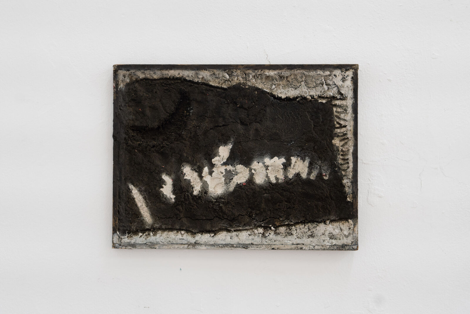 A black and white painting on a white wall.