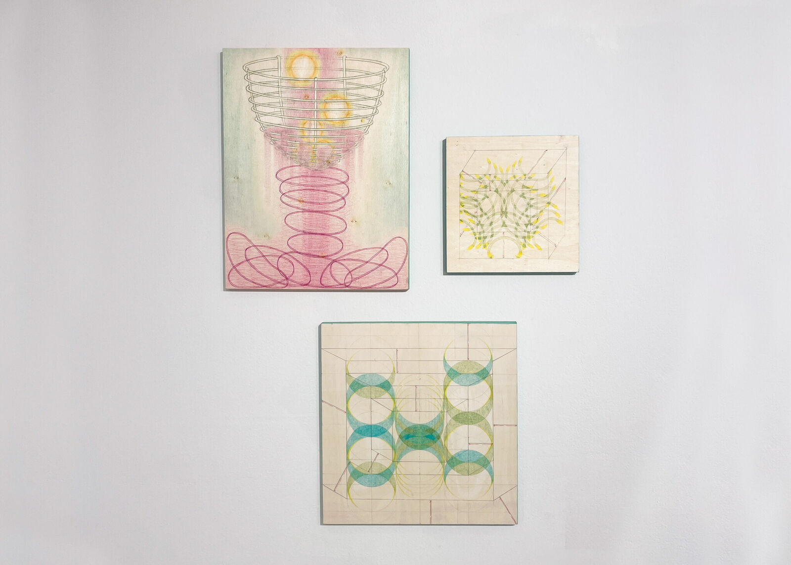 A surreal composition of a wire basket resting on a spring-like structure against a soft pastel background.