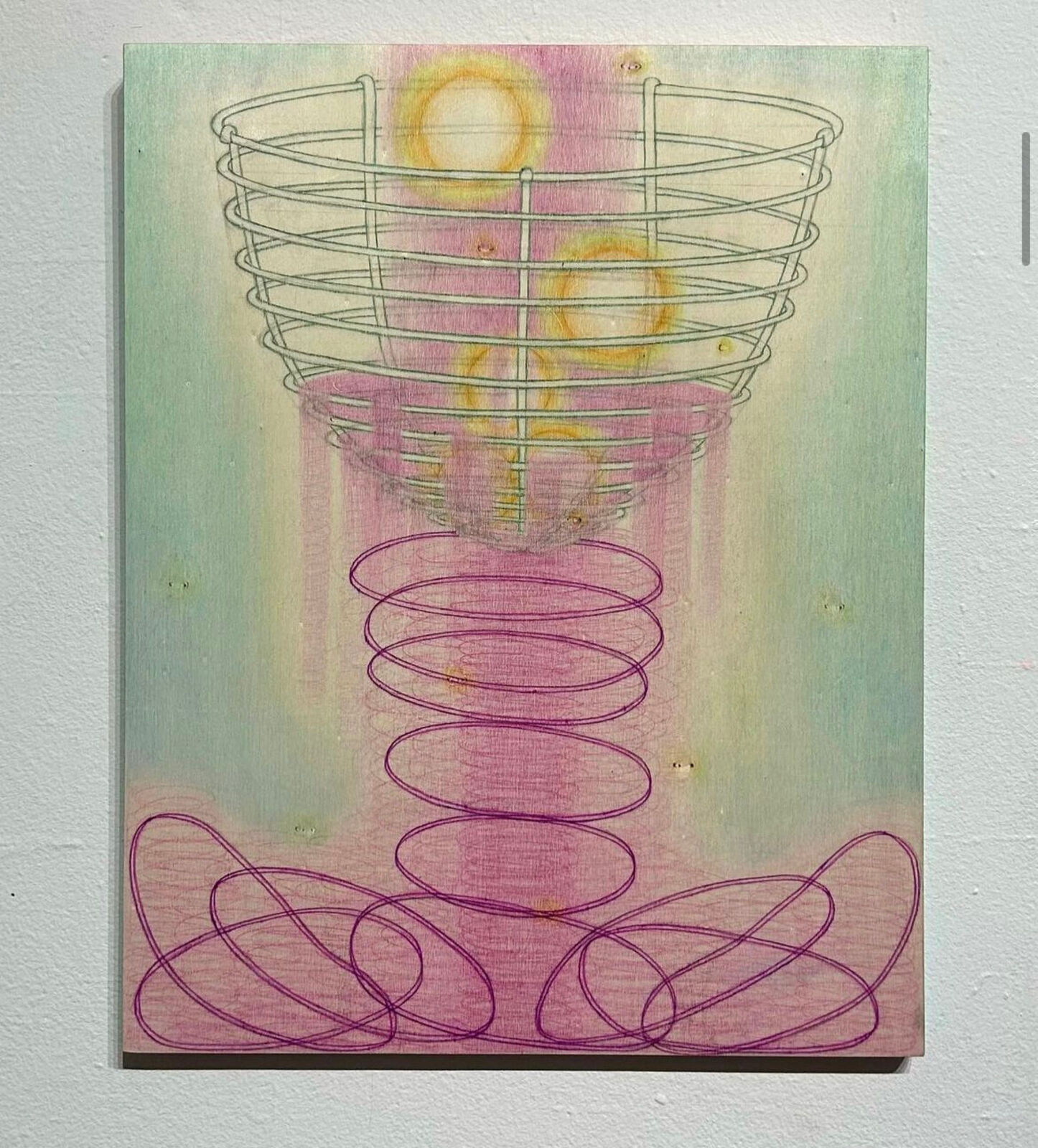 A surreal composition of a wire basket resting on a spring-like structure against a soft pastel background.