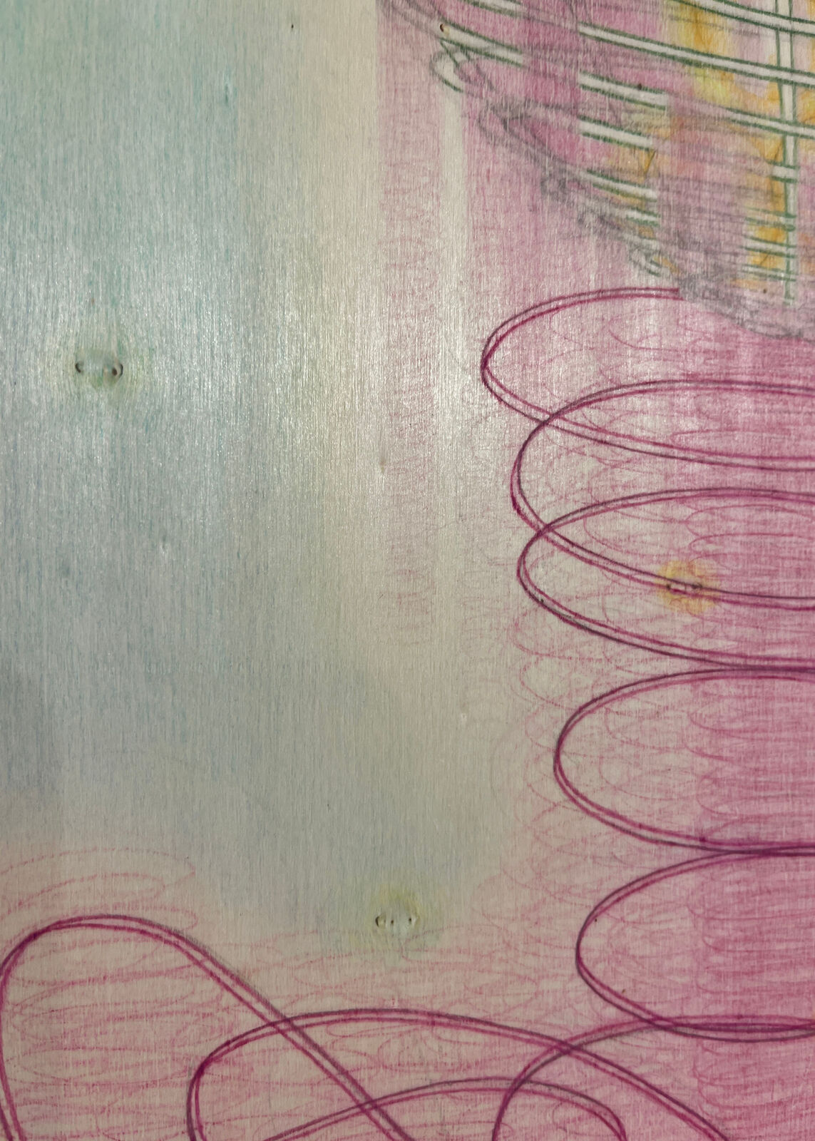 A surreal composition of a wire basket resting on a spring-like structure against a soft pastel background.