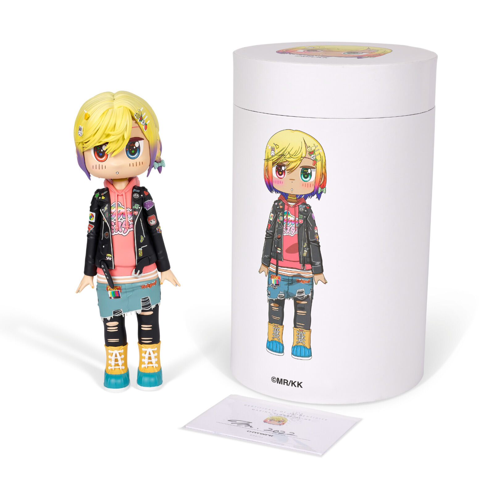 A doll with blonde hair wearing a black jacket and blue jeans.