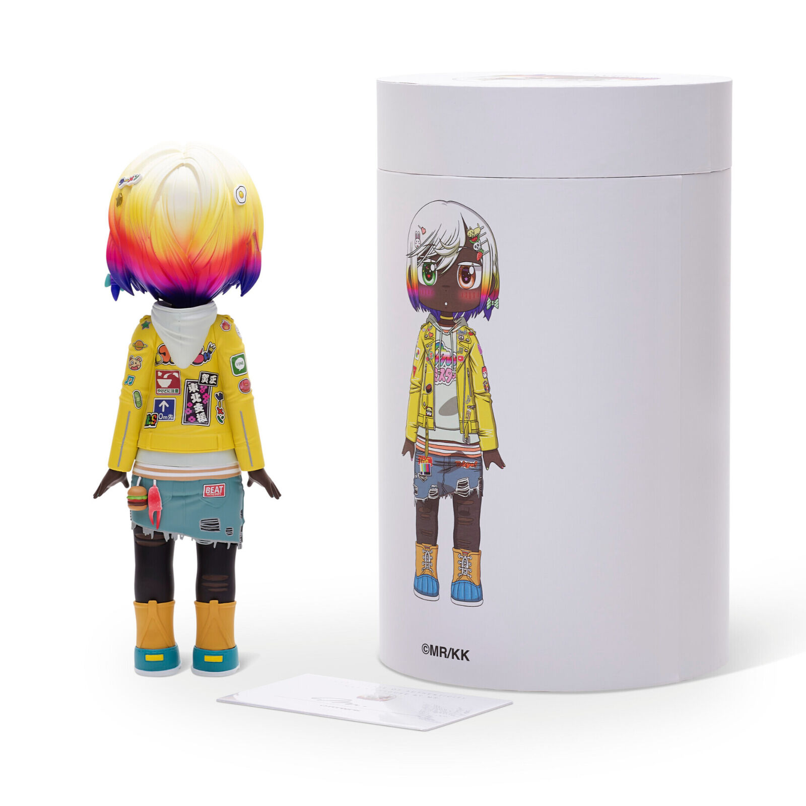 A doll with a yellow jacket and blue shorts.