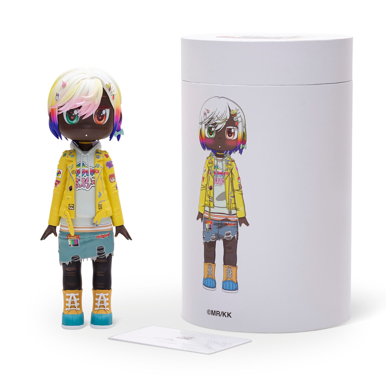 A doll with a yellow jacket and blue shorts.