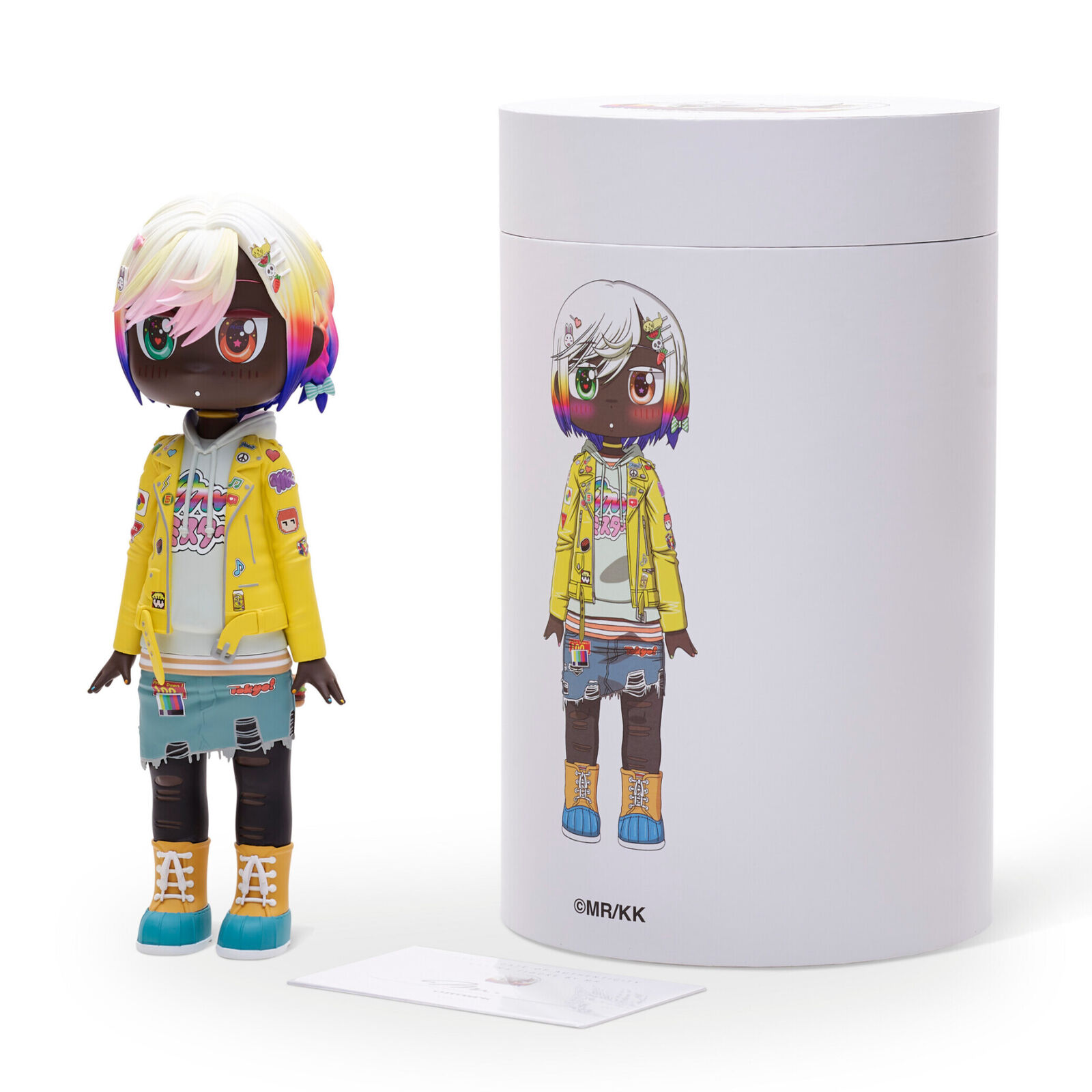 A doll with a yellow jacket and blue shorts.