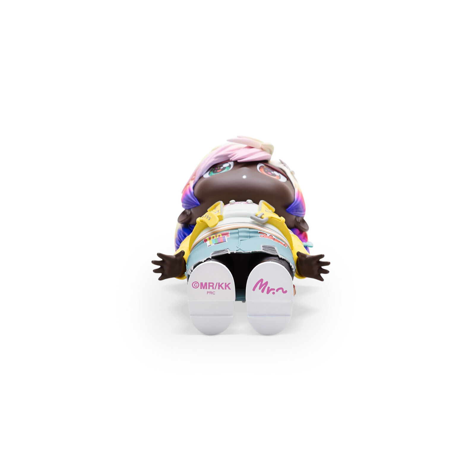 A doll with a yellow jacket and blue shorts.