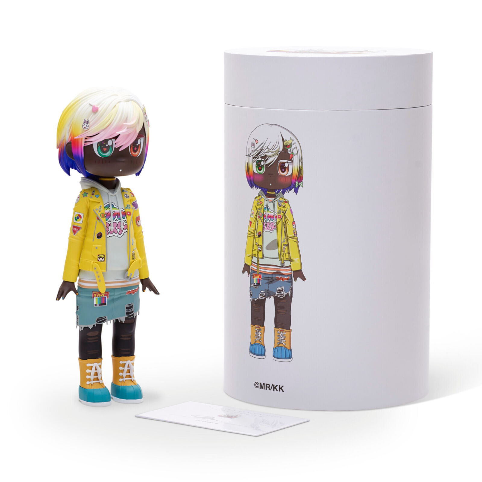 A doll with a yellow jacket and blue shorts.