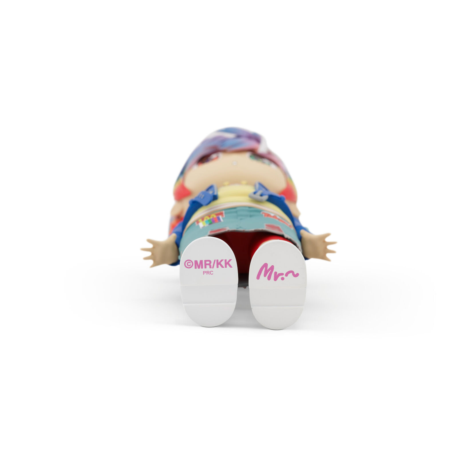 A doll with pink hair wearing a blue jacket and red pants.