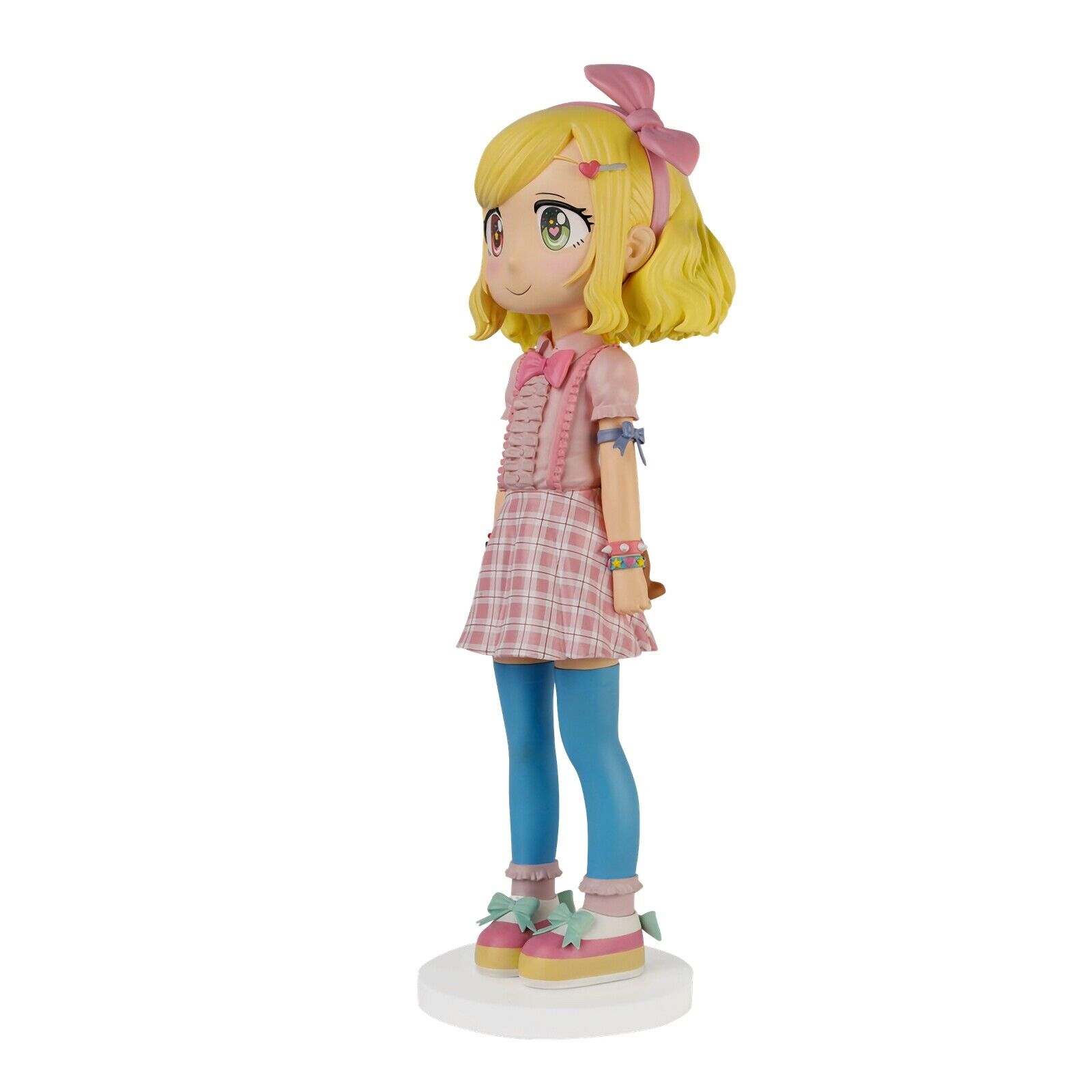 A figurine of a girl in a pink dress and blue tights.