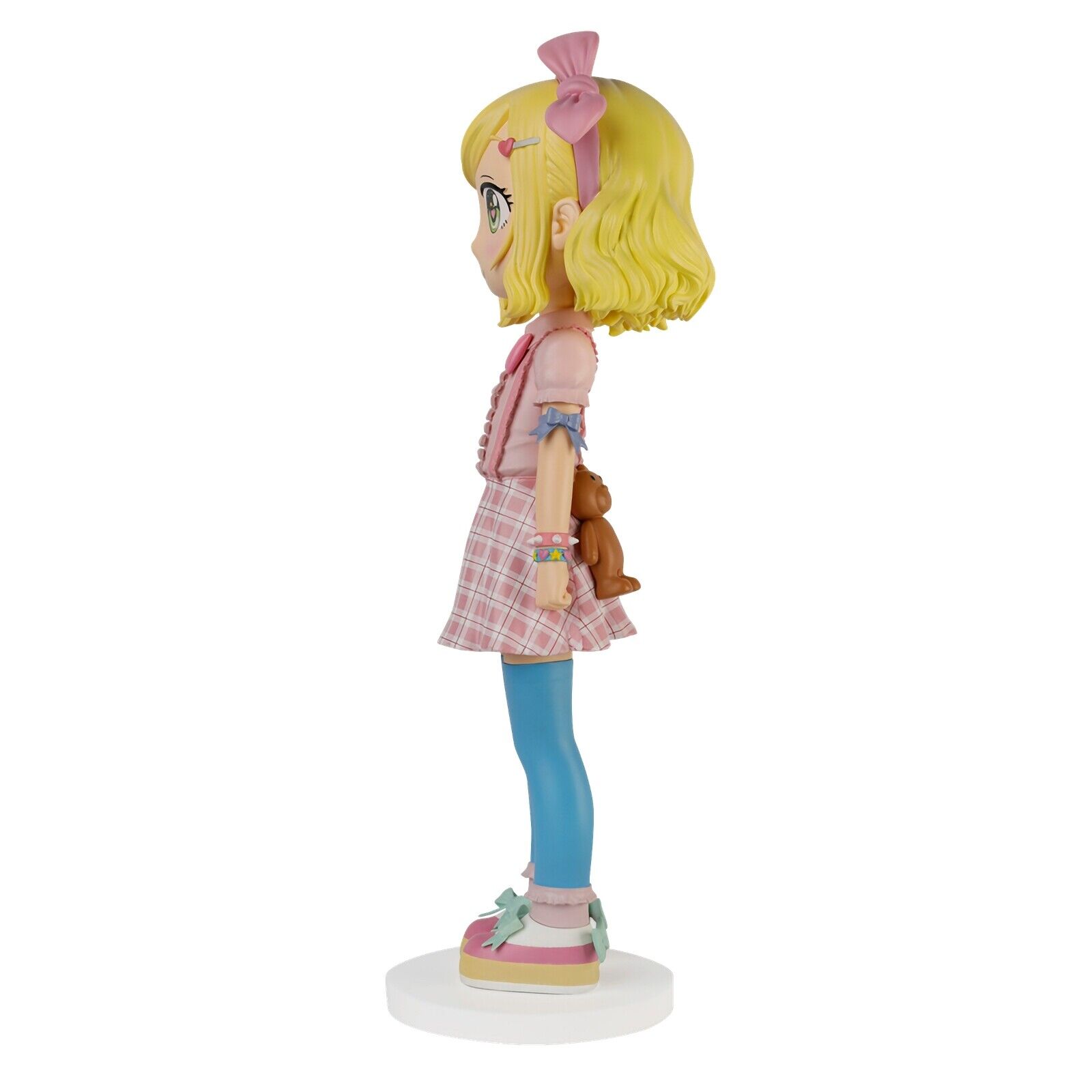 A figurine of a girl in a pink dress and blue tights.