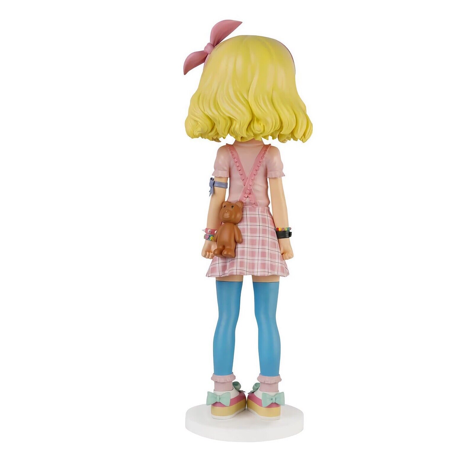 A figurine of a girl in a pink dress and blue tights.