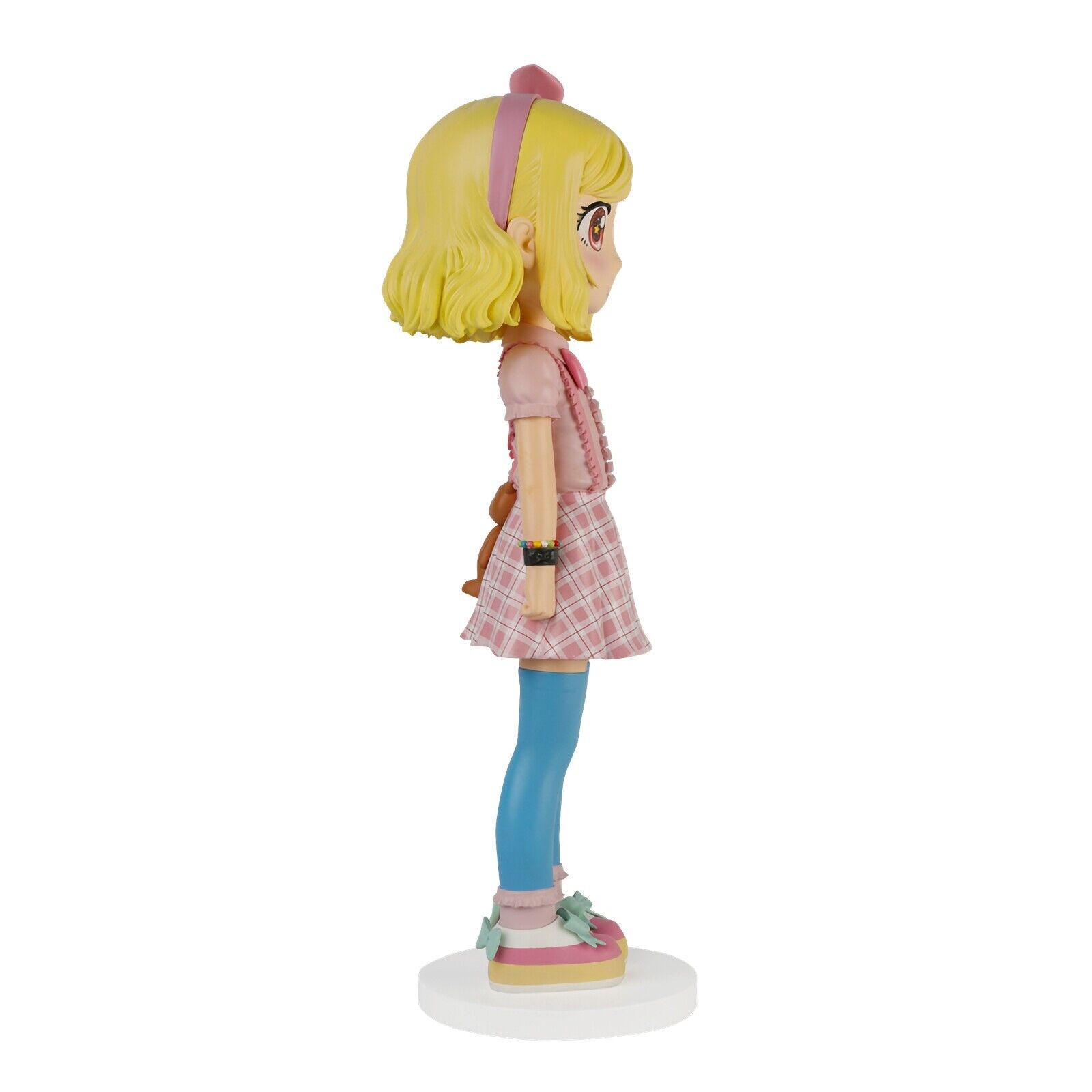 A figurine of a girl in a pink dress and blue tights.