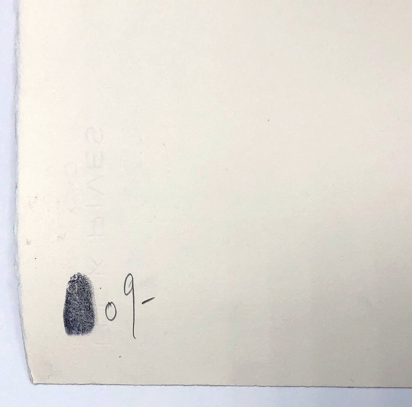 A black and white picture of a man standing in front of a wall with graffiti.