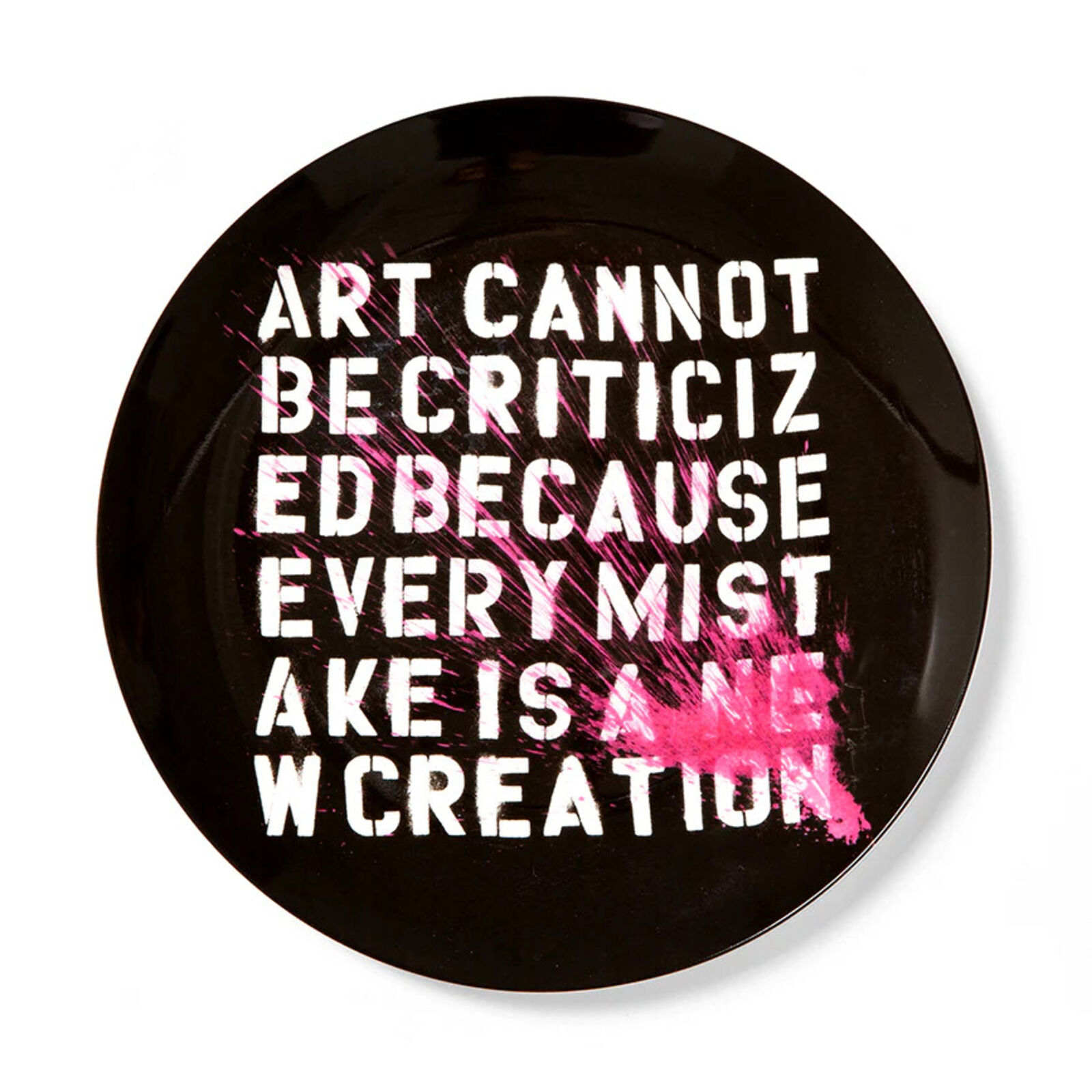 A black plate with a quote on it that says art cannot be criticiz ed because every mistake is a w creation.