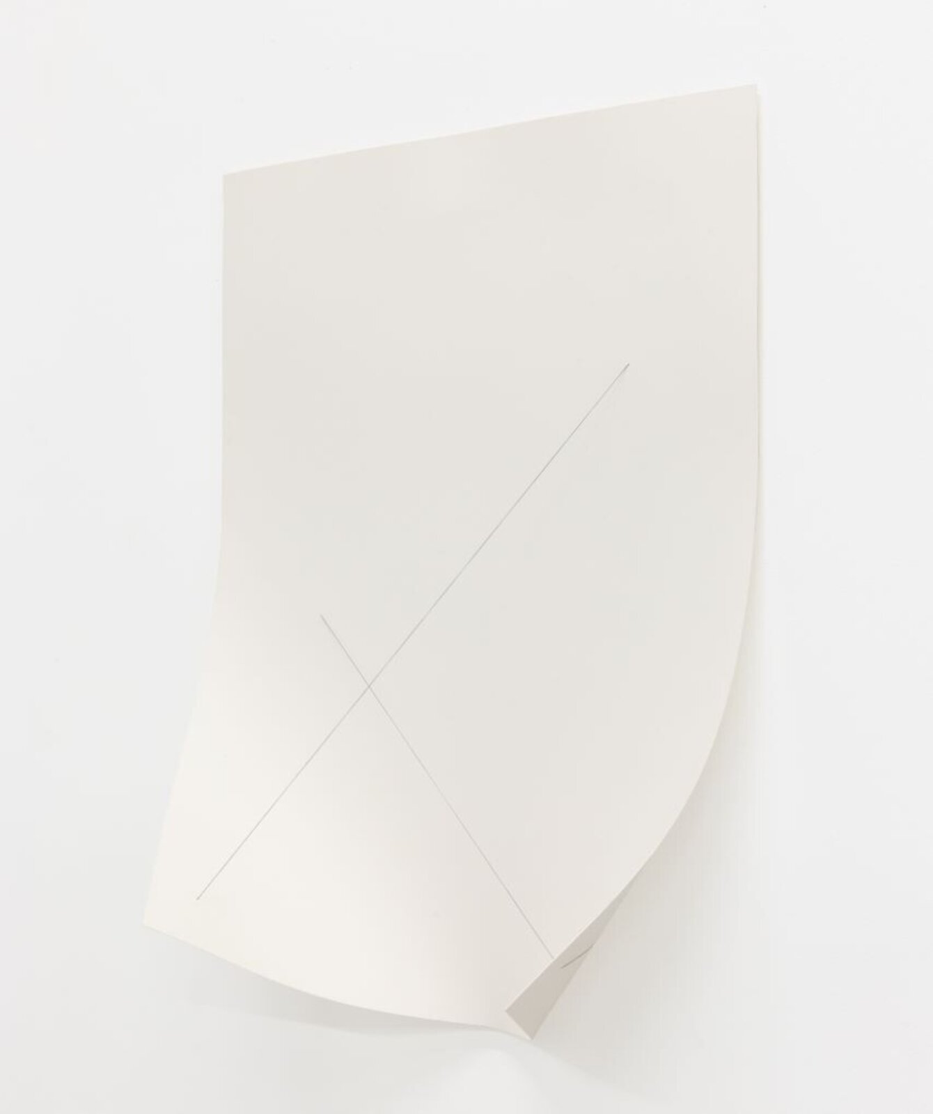 A minimalist composition featuring a folded white sheet with intersecting lines.