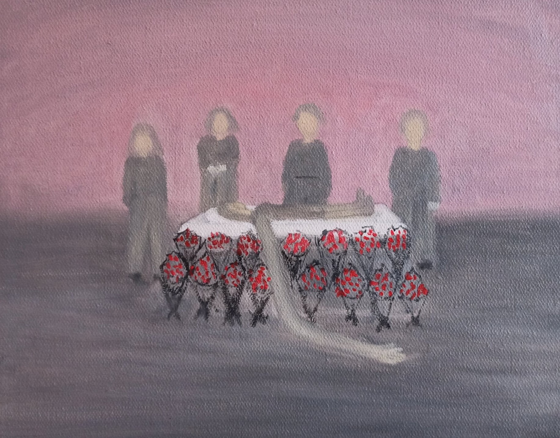 A somber scene of four figures standing behind a table laden with red flowers.
