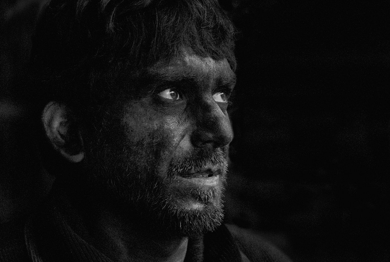 A black and white photo of a man with a beard.