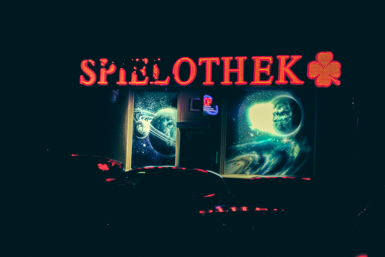 A neon sign that says Spillotek on a dark background.