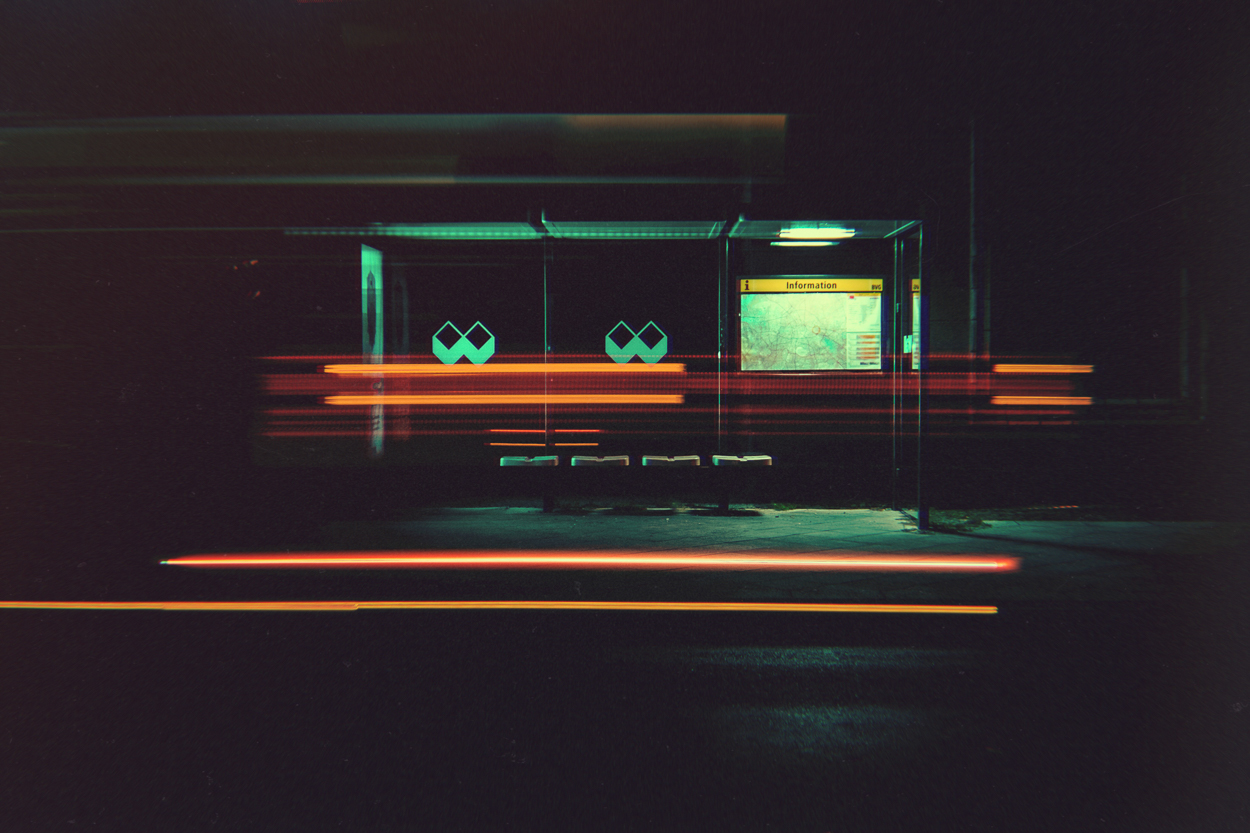 A bus stop at night with a long exposure shot.