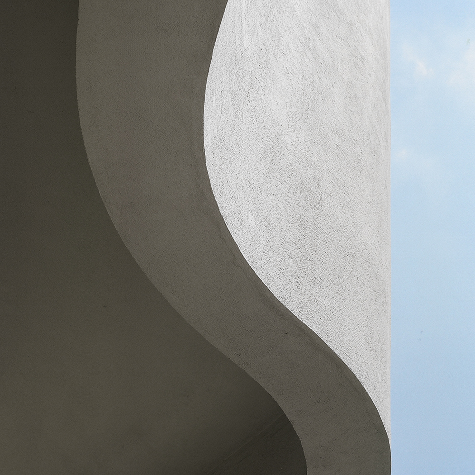 A white building with a blue sky in the background.