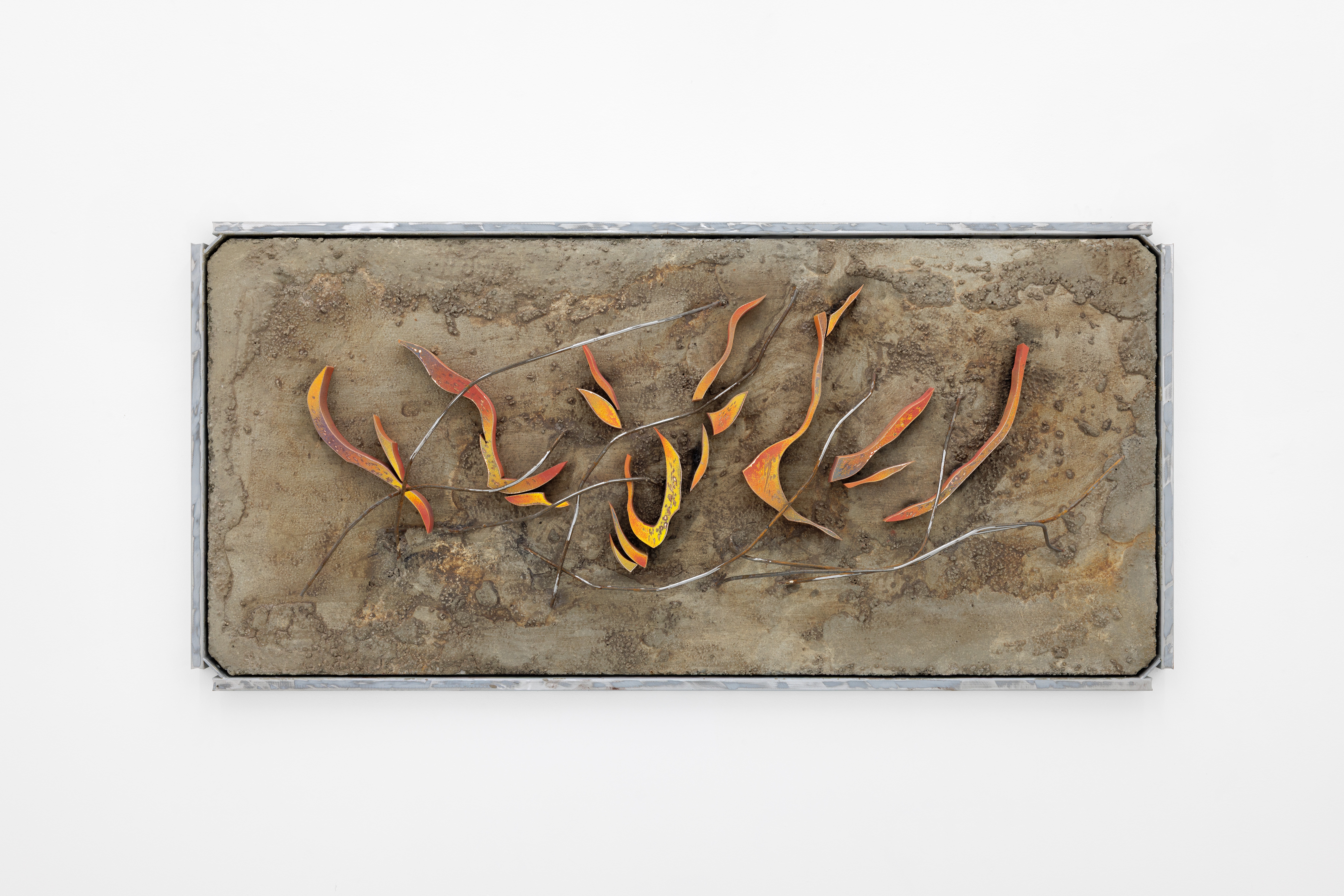 A metal sculpture on a white wall with a white background.