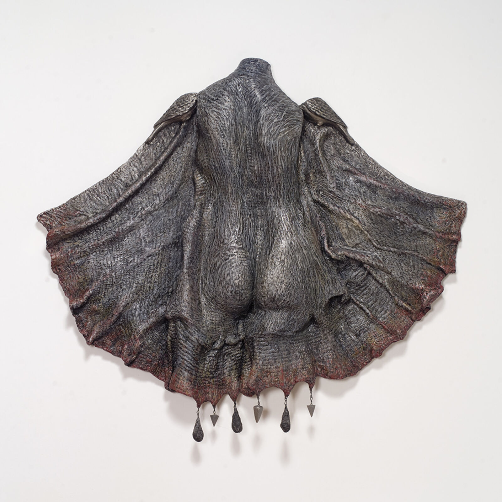 A sculpture of a woman's back with a large shell on it.