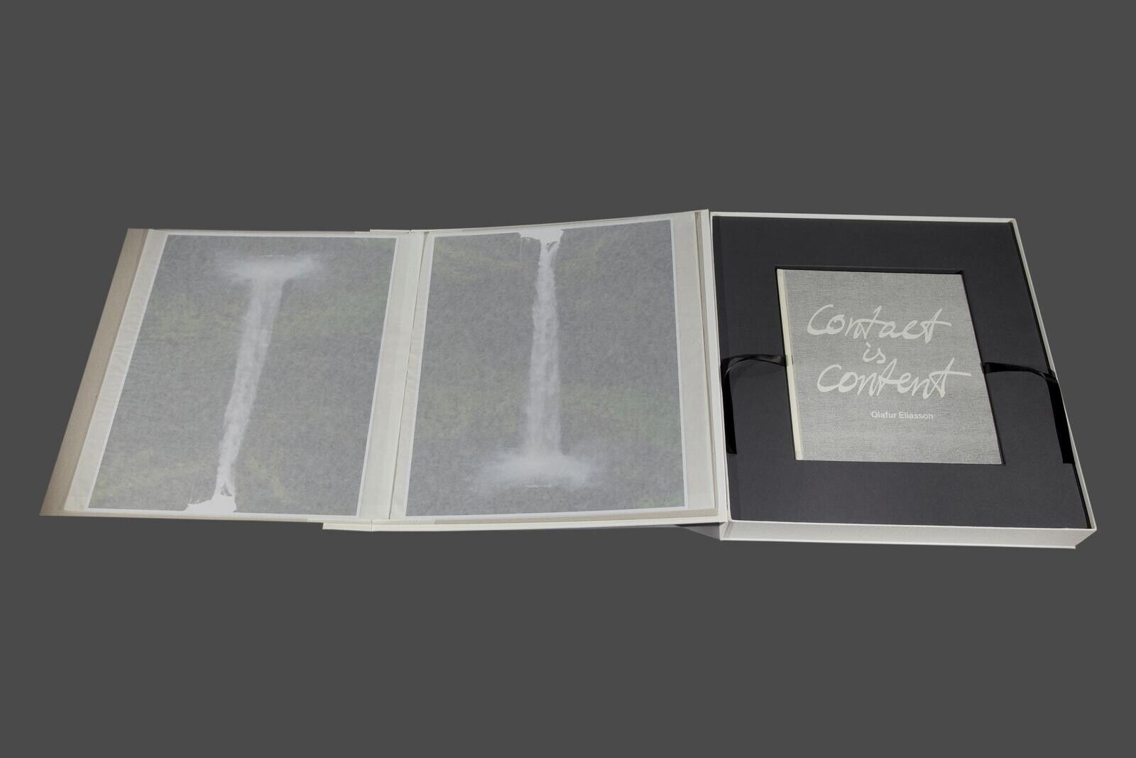 A white box with a black ribbon around it.