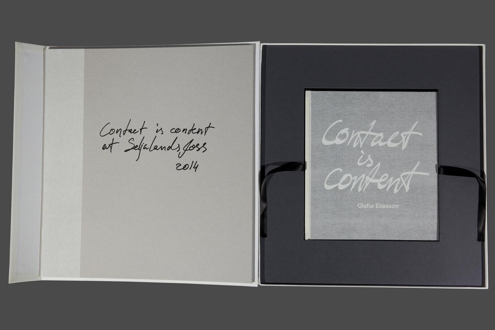 A white box with a black ribbon around it.