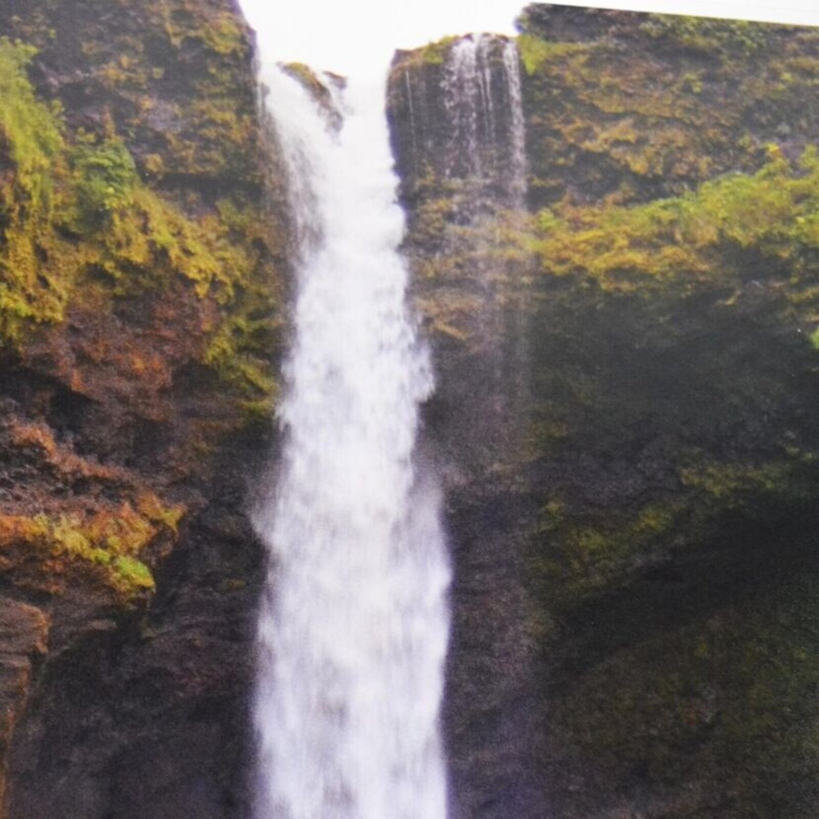 A split-panel framed artwork of a waterfall cascading over mossy rocks.