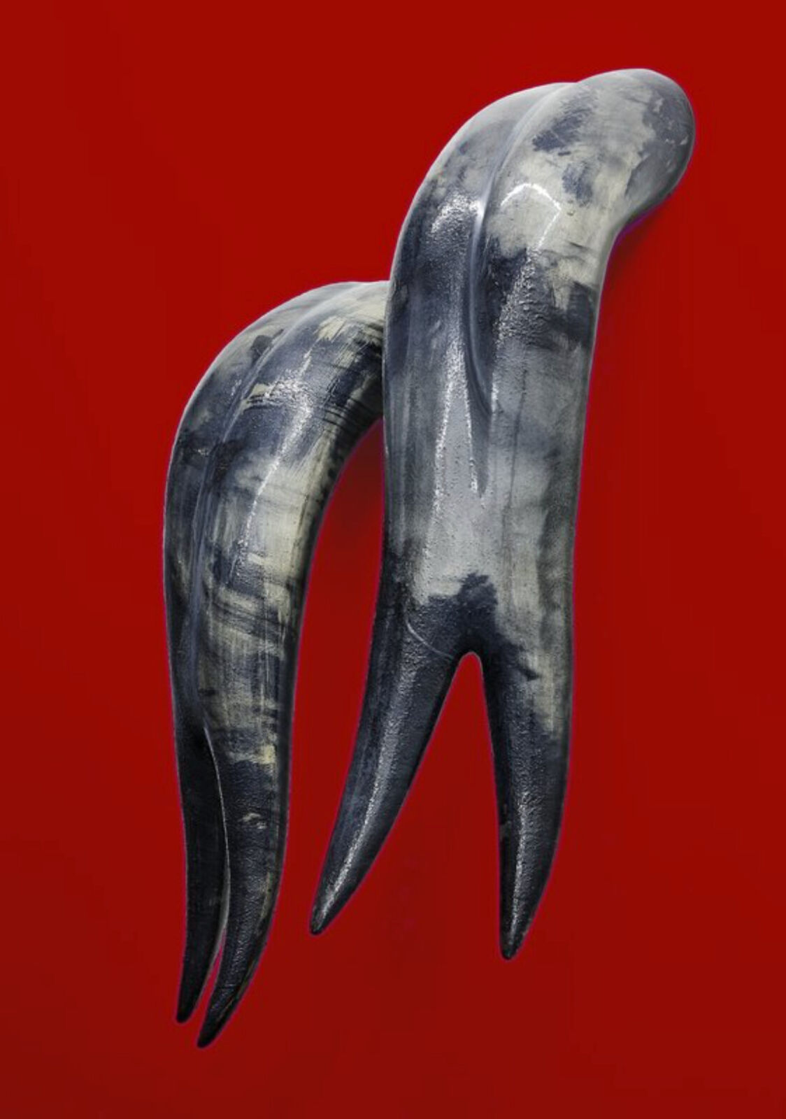A pair of horns on a red background.