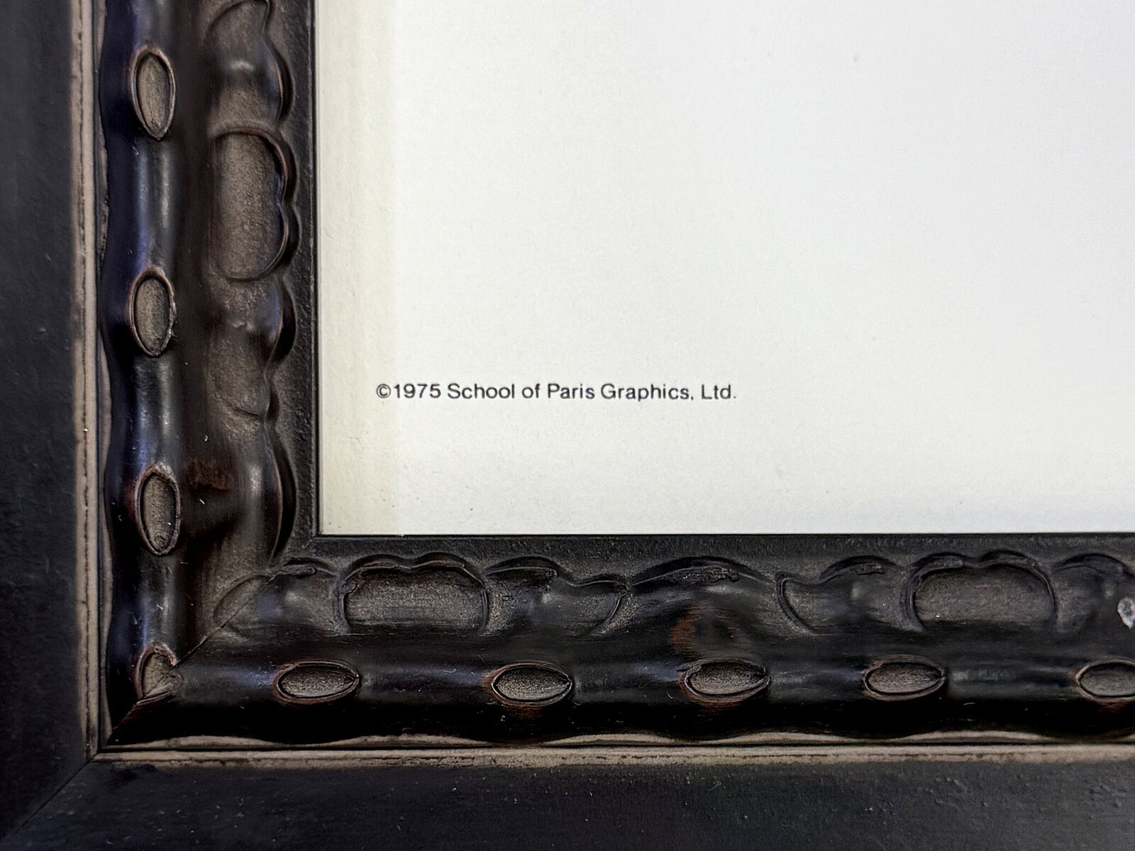 A framed poster of Picasso's school of Paris gallery.