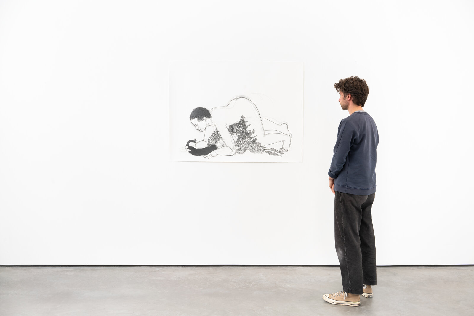 A drawing of a man and a woman laying on the ground.