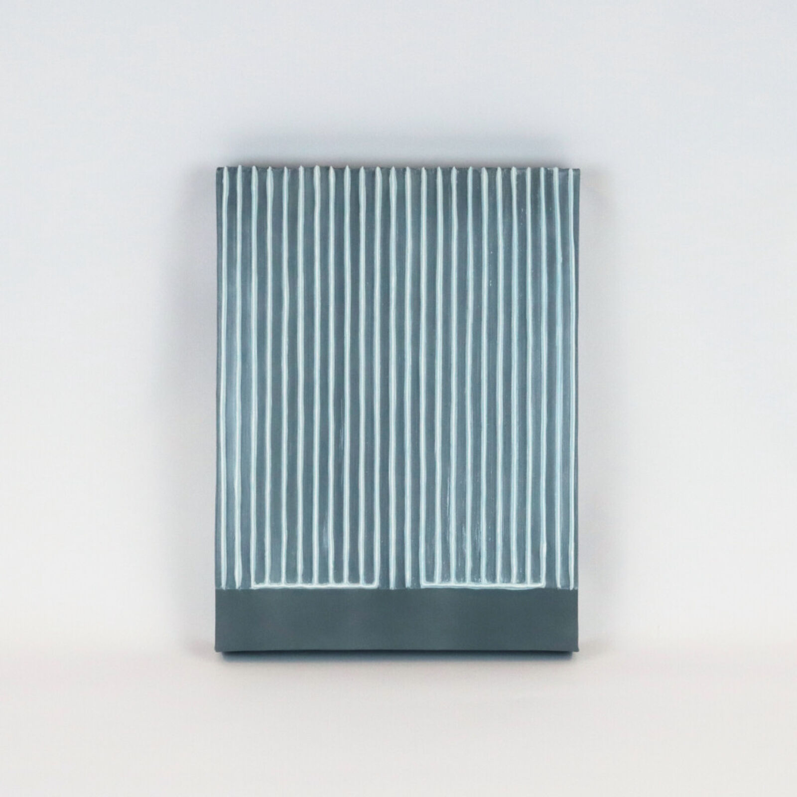 Two pieces of yellow and blue paper on a white surface.